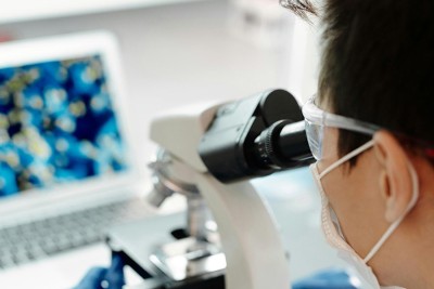 Researcher looking through microscope.jpg